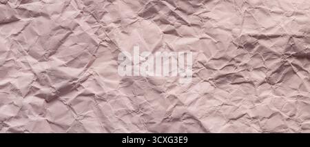 Textured Pink Crumpled Paper Background with Wrinkles and Folds Stock Photo