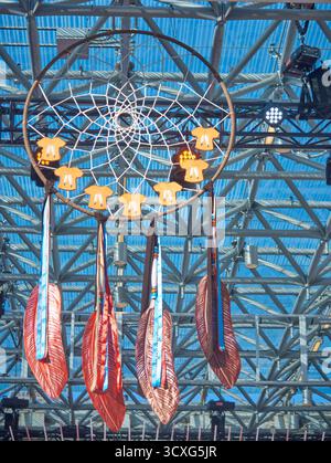 A dreamcatcher with orange shirts hanging from the top of a stage at Toronto City Hall's Nathan Phillips Square Stock Photo