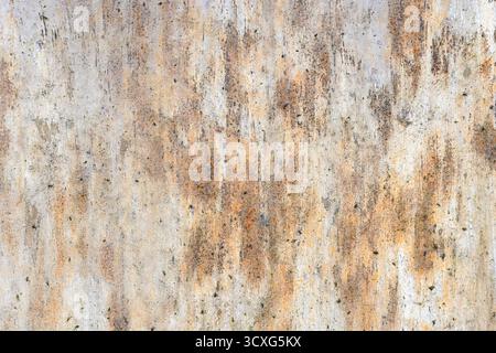 Rusted, weathered wall texture featuring orange-brown stains and a gritty grunge look. Ideal for backgrounds, design projects or urban and industrial Stock Photo