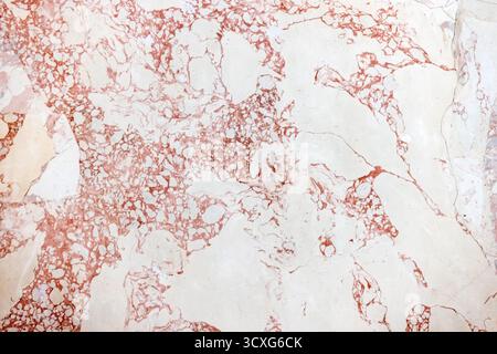 White pink marble surface with red veins creates an elegant, abstract background suitable for luxury design, interiors, backgrounds, and editorial lay Stock Photo