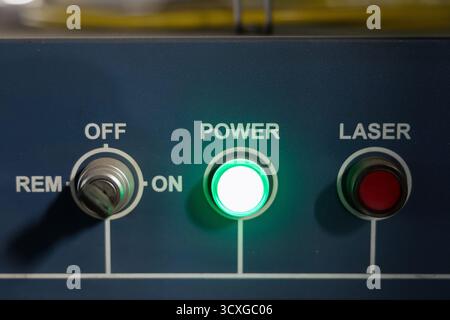 The control panel has a glowing power indicator and buttons for on off and laser functions, used in boiler manufacturing. Stock Photo