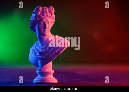 Decorative Plaster Head in Blue Red Gradient Light Installation Stock Photo
