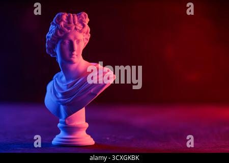 Decorative Plaster Head in Blue Red Gradient Light Installation Stock Photo