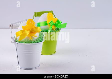 Easter decor with selective focus. Holiday still life with decorative eggs in a buckets with copy space for text Stock Photo