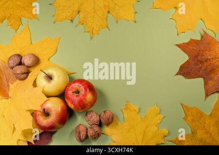 Autumn Harvest Composition with Apples, Walnuts, and Maple Leaves Stock Photo