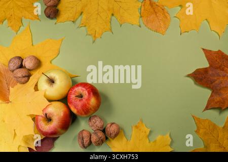 Autumn Harvest Composition with Apples, Walnuts, and Maple Leaves Stock Photo