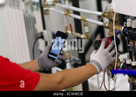 Installing collector for warm water underfloor heating system. Plumber work. Stock Photo