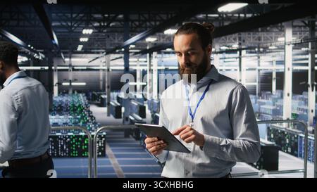 Computer scientists in data center monitoring neural network LLM visualization. Industrial; server farm IT professionals overseeing rigs powering machine learning processes, Stock Photo