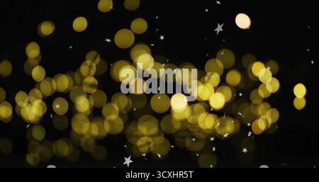 Golden bokeh lights with star shapes image on black background Stock Photo
