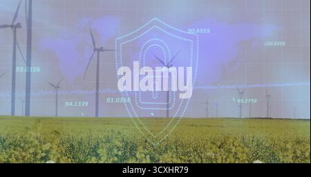 Displaying digital padlocked shield icon overlaying yellow field at wind farm, with wind turbines Stock Photo