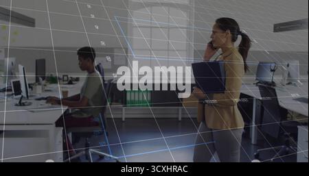 Speaking on smartphone Korean woman holding dark blue folder in modern open plan office, copy space Stock Photo