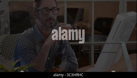Holding ceramic mug man with eyeglasses analyzing code on computer monitor at desk, with plant Stock Photo
