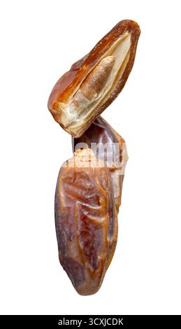 Ripe dried date palm fruits with half in stack are isolated on white background with clipping path. Concept of iftar food in Ramadan month for Muslim Stock Photo