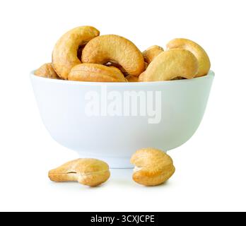 Brown cashew nuts in stack in small white cup are isolated with clipping path. Stock Photo