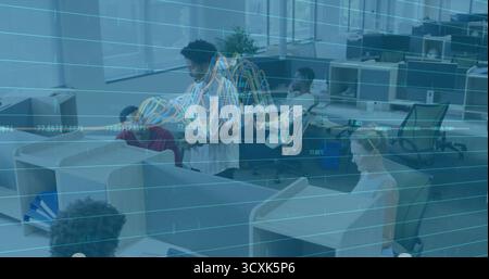 Coworker group working on desktop computers and laptops in cubicle office, with grid overlay graphs Stock Photo
