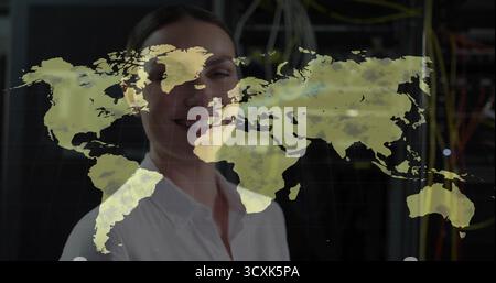 IT engineer wearing white shirt analyzing projected world map in server room, with racks and cables Stock Photo