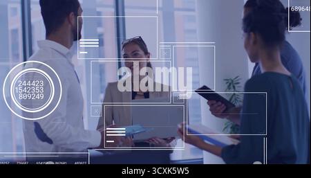 Discussing strategy team members analyzing data on laptop in modern office, with digital overlays Stock Photo