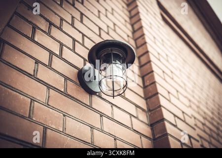 Street lamp on the wall of a brick building Stock Photo