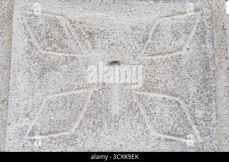 Concrete wall surface with carved geometric pattern and rough texture perfect for background, architecture and design concepts Stock Photo