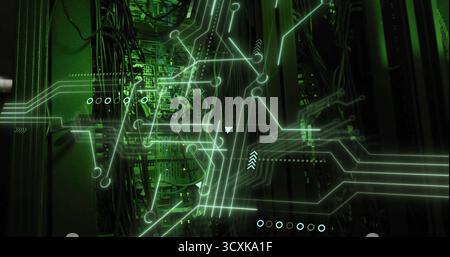 Server racks displaying network flow in dimly lit data center, with cables, green circuit overlay Stock Photo