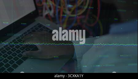 Typing engineer's right hand on silver laptop keyboard in server room, with data overlay and cables Stock Photo