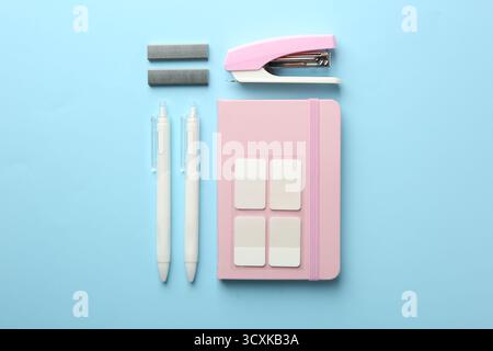 Stapler and other stationery on light blue background, flat lay Stock Photo