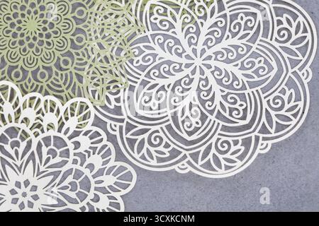 Lace doilies with very detailed designs on a grunge grey background Stock Photo