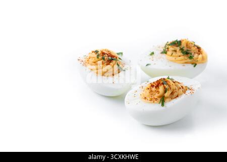 Homemade hard Boiled Deviled Eggs garnished with herbs isolated on white background Stock Photo