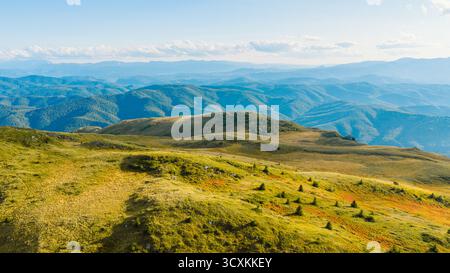 Aerial view of the rolling green hills and lush forests of the ...
