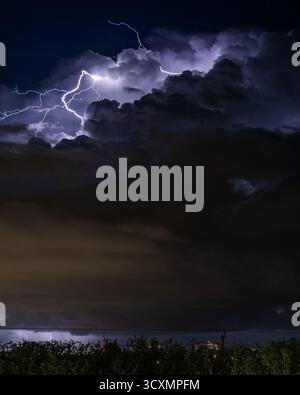 Billowy cloud with lightning coming out of it Stock Photo