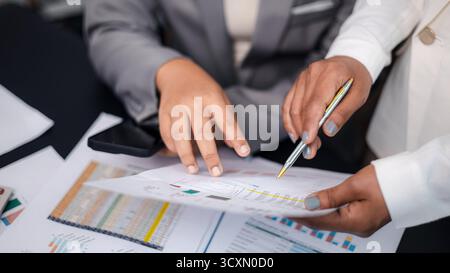 Close-up of business team discussing financial charts and data reports, concept of teamwork, business analysis, and digital strategy planning in moder Stock Photo