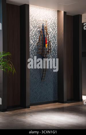 Modern hotel corridor with metal rod sculpture in wall niche Japan Stock Photo