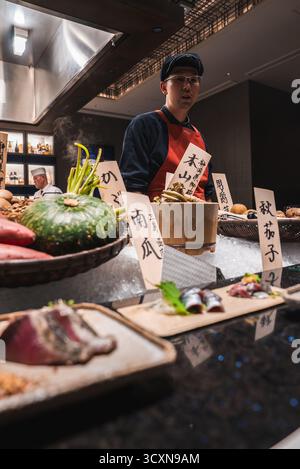 Japanese chef prepares omakase at luxury hotel restaurant in Japan Stock Photo