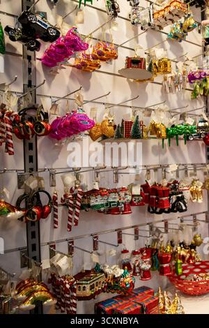 Christmas decor store, Variety of Christmas tree decorations in the form of objects and transport and curly balls Stock Photo