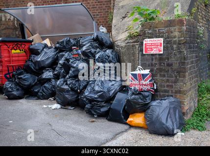 Black bin bags and Marks & Spencer bag Redhill, UK Stock Photo