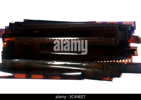 a stack of photographic film strips, typically 35mm film that was a common format for still photography, the small rectangular images on the film are Stock Photo