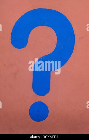 Marrakech, Morocco, Africa: a blue question mark on a pink wall in the alleys of the medina, sightseeing in  the old city Stock Photo