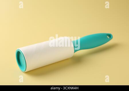 One lint roller on yellow background, closeup Stock Photo