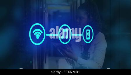 Technician using tablet monitoring server LEDs showing turquoise icons in datacenter, copy space Stock Photo