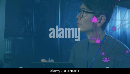 Network engineer monitoring server racks in server room, with tablet and purple overlay, copy space Stock Photo