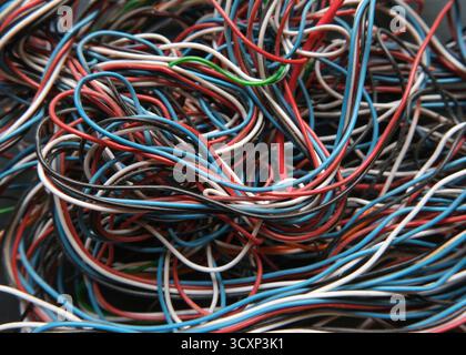 Chaotic cables on a black background. Colorful abstract thin wires texture. Stock Photo