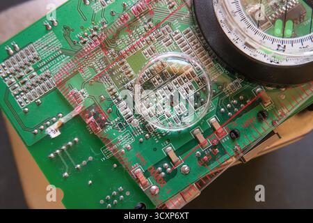 A close-up view of the microelectronic world: A circuit under the magnifying glass. Selected focus. Stock Photo