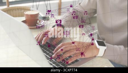 Typing man wearing beige top at cafe table, with silver laptop and floating purple network icons Stock Photo