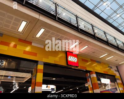 Manchester, UK - September 26, 2025: Bright Lego store facade with yellow bricks, bold sign, and glass balcony in a shopping mall. Stock Photo