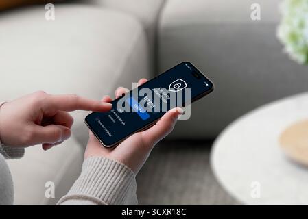 User entering 2FA code on smartphone screen with security shield icon, representing secure login, verification, and multi-factor authentication Stock Photo