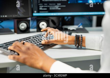 Close up of IT expert typing on PC keyboard in server hub with hardware supporting data mining. Computer scientist working in data center to do maintenance on rigs using device Stock Photo