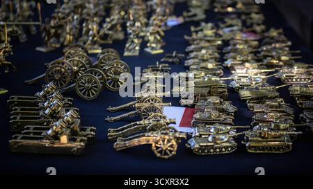 Detailed arrangement of antique miniature military figures showcasing historical warfare equipment, perfect for collectors and hobbyists Stock Photo