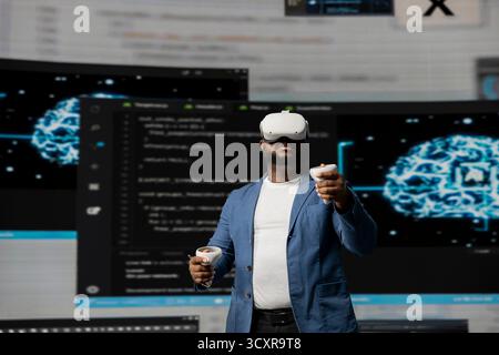 African American programmer engaging in virtual reality with a headset, focusing on system development. Utilizing code on terminal window to debug and design new software. IT career. Stock Photo