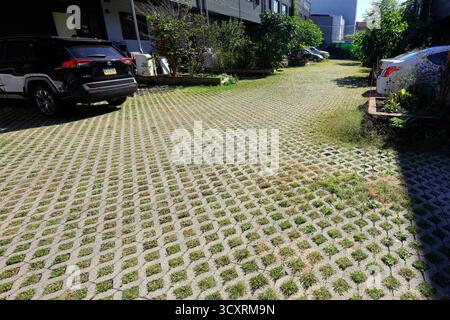 A driveway containing permeable pavers at an apartment in Philadelphia. The pavers help mitigate stormwater from entering sewers during a rain storm w Stock Photo