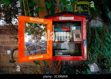 A Little Free Library book sharing box containing books of fiction. Stock Photo